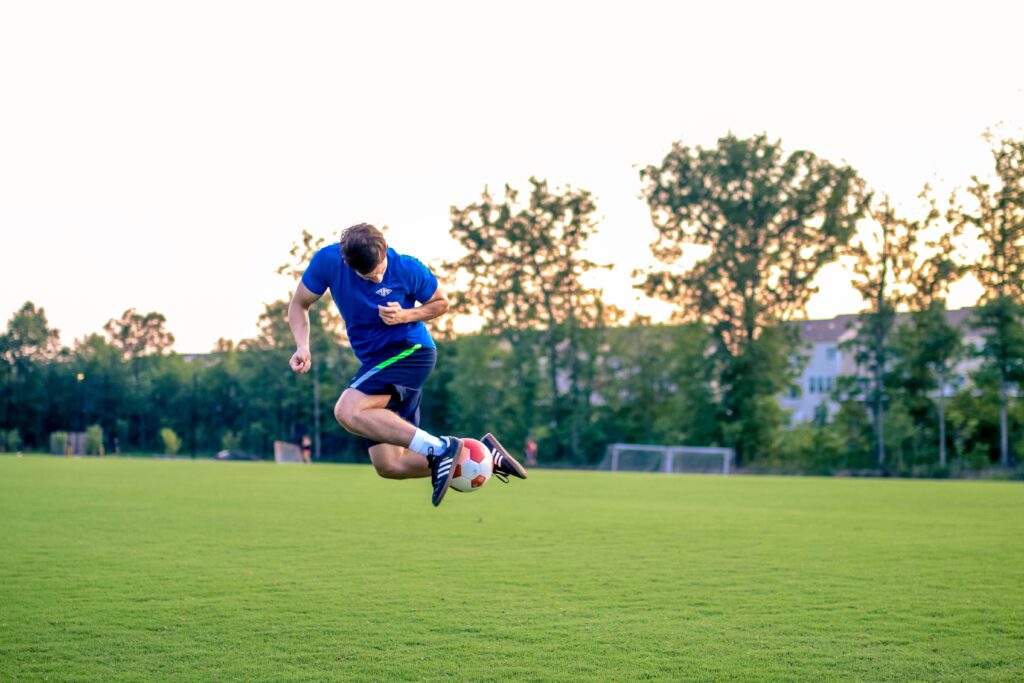 Young man practicing soccer footwork