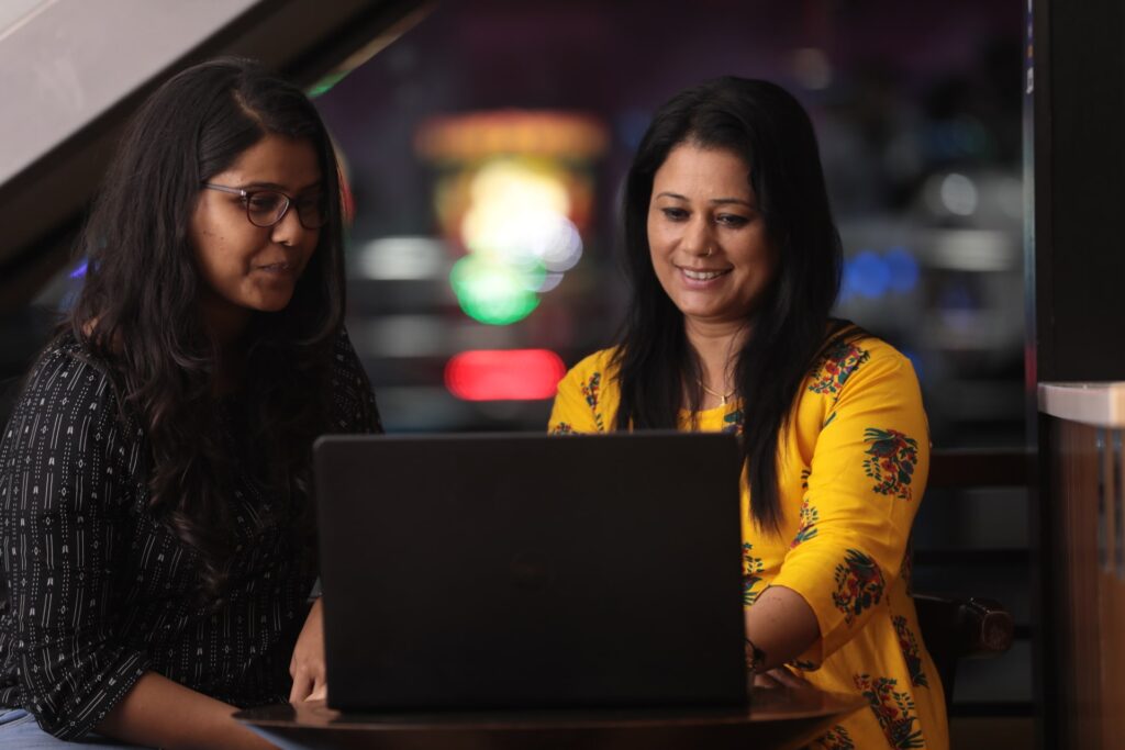 Two women working together on a computer